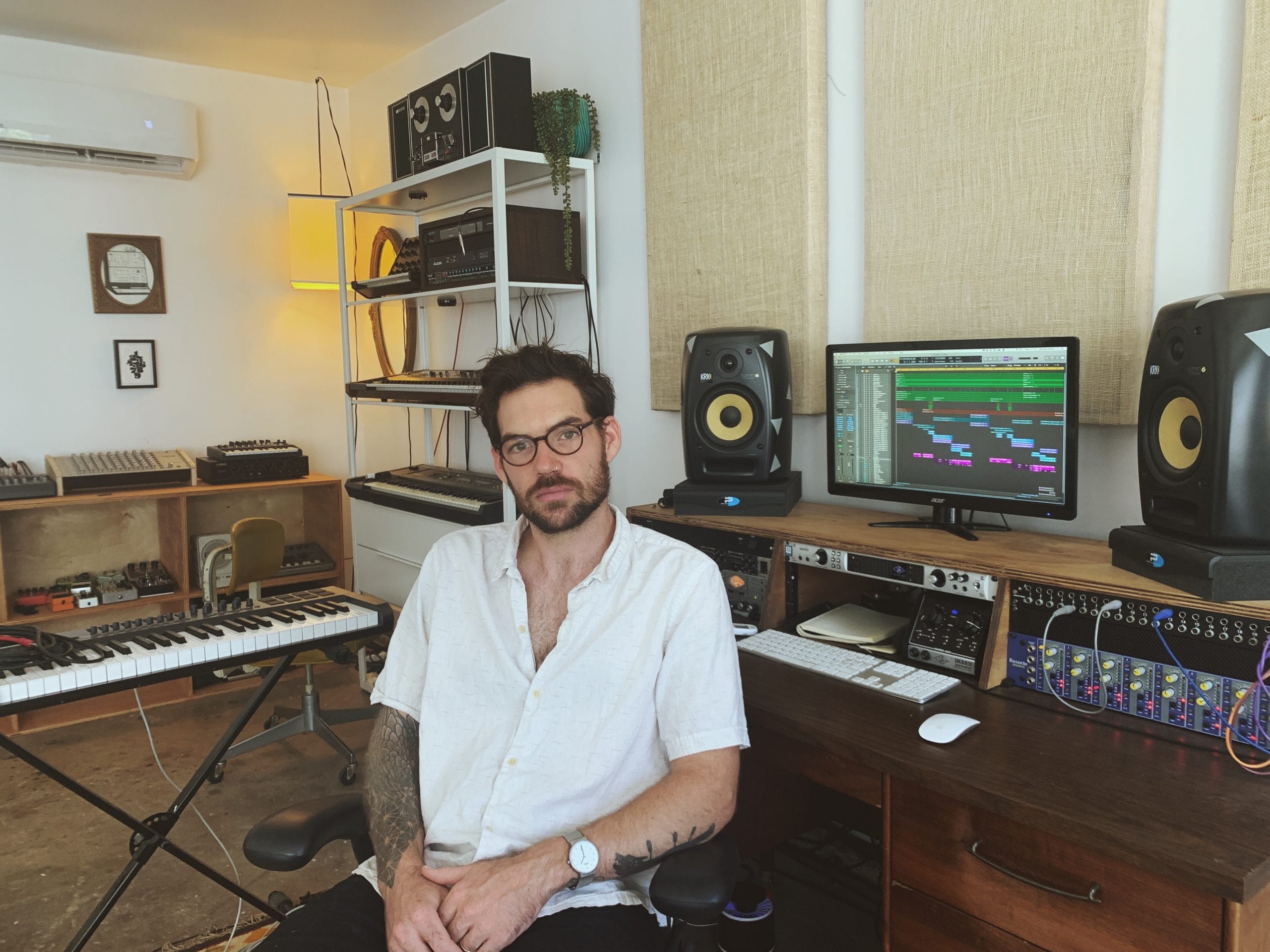 An engineer at a mixing console with Recoil studio monitors